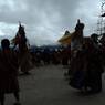 Gonpo Gonmo chham nearby Guru statue as people rushes for offering of their grains