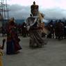 People following Gonpo Gonmo dancers circumambulating statue