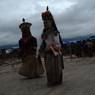 Dancers dancing having huge mask on their head circumumbulating the statue