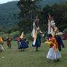 Nub chham dance performing in circle at meadow near by temple