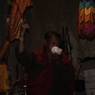 A Gomchen is blowing conch at Khar lhakhang